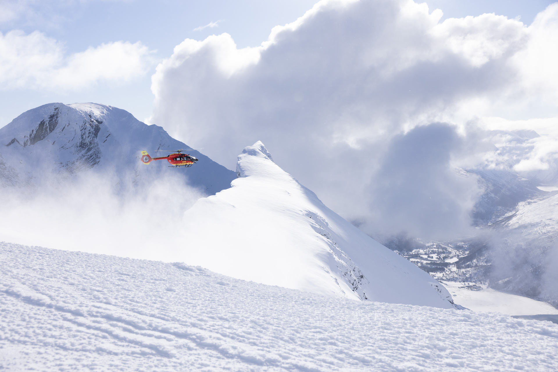 Helicopter over snowy mountains